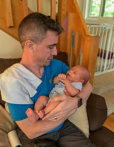 Dr. Andrew Elliston holding a newborn baby